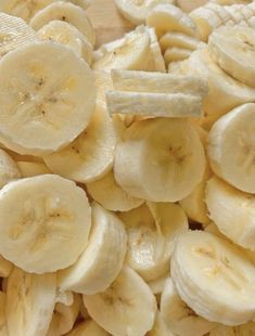 sliced bananas are sitting on a cutting board