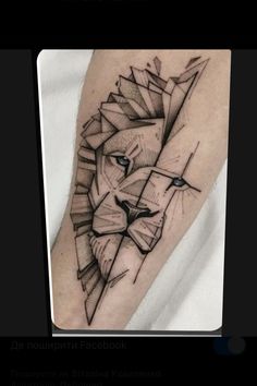 a black and white tattoo of a lion on the arm with geometric shapes around it