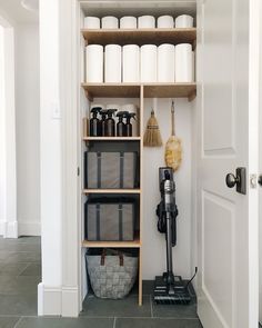 the shelves in this bathroom are filled with cleaning supplies