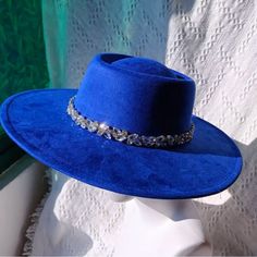 This Fedora Hat Features A Unique Raw Diamond Design On Its Round Brim. Express Your Individuality With This Fashionable And Durable Accessory. Made From High-Quality Materials, It's Perfect For Completing Any Stylish Outfit. Stand Out From The Crowd With This One-Of-A-Kind Fedora. Fedora Details Material (Interior): Vegan Suede Material (Exterior): Vegan Suede Size: 56-58cm Hat Brim: 10cm Hat Height: 12cm Adjustable Straps Inside Unisex Shipped In Blue Flat Brim Felt Hat For The Beach, Blue Fedora For Summer Parties, Blue Summer Fedora For Parties, Adjustable Blue Fedora For Parties, Blue Fedora With Short Brim For Parties, Blue Fedora For Spring Party, Blue Summer Party Fedora, Blue Short Brim Felt Hat For Party, Blue Curved Brim Felt Hat For Party