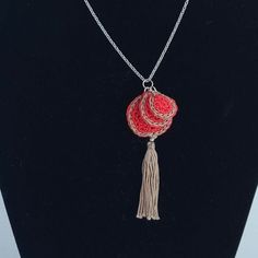 This is an elegant  small round double sided crochet pendant with a pretty combination of red and  brown ,with a  matching tassel and decorated with a stainless steel bead in silver colour. It is hanged from a stainless steel chain in silver colour . It can be worn both sides.  This necklace can elevate every daily outfit. The chain is 45 cm long The diameter of the biggest circle is 2,5 cm  The tassel lenght is 3 cm It is made with 100% merserised cotton yarn . This motif comes also in other co Red Tassel Necklaces As Gifts, Red Tassel Necklaces For Gifts, Brown Tassel Necklaces As Gifts, Red Tassel Necklace For Gift, Bohemian Brown Crochet Jewelry, Brown Bohemian Crochet Jewelry, Handmade Tassel Necklace As Gift, Handmade Long Tassel Necklace Gift, Handmade Dangle Tassel Necklace For Gift