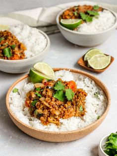 three bowls filled with rice, meat and cilantro garnished with limes