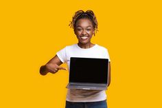 a woman holding a laptop and giving the thumbs up sign with both hands on a yellow background