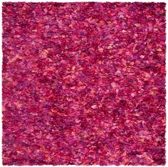 an area rug with pink and red colors