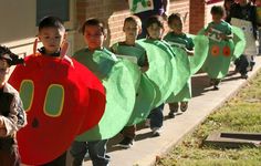 children in costumes are walking down the street