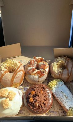 a box filled with lots of different types of doughnuts