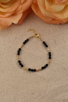 Black Onyx Bead Bracelet, 14Kt Gold Filled - Gemstone Jewelry Gifts for Women Adjustable 7 inches - 8 inches Black and gold create a perfectly elegant combination. This bracelet is easy to match with any outfit, adding an effortless elegance. You will love the bright sparkle of the gold beads, and the flashes from the dark surfaces of the faceted Onyx beads.  What is Gold Filled? Gold filled jewelry has a layer of solid gold that is 100 times thicker than that of gold plated jewelry. It is hypoallergenic, resistant to tarnish, and will not chip or fade over time. Gold filled has an appearance nearly identical to solid gold, but with a more affordable price. It is highly durable and with proper care will last a lifetime. Browse my shop: ALLDANAE.etsy.com Adjustable 14k Gold-filled Bracelets With Faceted Beads, Gold Beaded Bracelets With Onyx Gemstones, Gold Onyx Beaded Bracelets With Gemstones, Hand-strung Onyx Jewelry In Gold, Black Bracelet With Gold Beads, Dainty Black Beaded Bracelets For Gift, Dainty Beaded Gold Bracelet, Gold Crystal Bracelet With Round Black Beads, Gold Onyx Beaded Bracelets With Black Beads