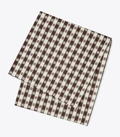 two brown and white patterned napkins on top of each other