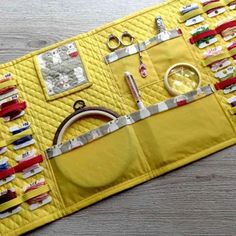 a yellow quilted place mat with sewing supplies on it