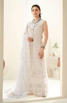 White Embroidered Pakistani Salwar Kameez with Dupatta is an elegant festive attire beautifully adorned with hand-worked details of threads and motifs. Traditional Sleeveless Anarkali Set For Wedding, White Sleeveless Kurta With Zari Work, Elegant Sleeveless Salwar Kameez For Wedding, Sleeveless Chanderi Kurta For Wedding, Elegant Sleeveless Designer Traditional Wear, Elegant Sleeveless Chinon Sets, Sleeveless Anarkali Traditional Wear For Wedding, Reception Unstitched Chikankari Embroidery Straight Kurta Suit, Sleeveless Anarkali For Wedding