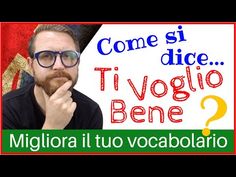 a man with glasses and a beard in front of a sign that says come si dice ti voglio bene?