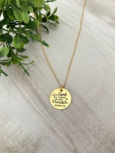 A beautiful dainty 16k gold plated necklace engraved with "with God all things are possible Mathew 19:26". Perfect Easter gift, Christian jewelry, baptism, gift for mom. Charms are gold plated over stainless steel. Plated jewelry is a wonderful, affordable way to add a sophisticated look to your wardrobe, with the look of real gold. It is also an excellent choice for people with sensitive skin. CARE TIPS: Avoid contact with perfumes, body oils, and other chemicals, including household cleaners. Gold Brass Necklaces For Blessing, Spiritual Gold-plated Necklaces For Blessings, Be Still Necklace, Spiritual 14k Gold-filled Charm Necklaces As Gift, Scripture For Necklace, Bible Verse Jewelry, Christian Jewelry, Baptism Gifts, Engraved Necklace