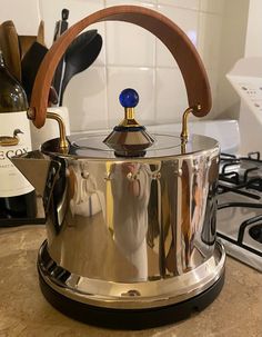 a large pot sitting on top of a kitchen counter next to a bottle of wine