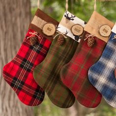 three christmas stockings hanging from a tree