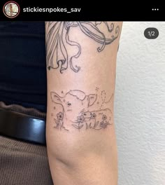 a person with a tattoo on their arm that has an image of a cow in it