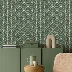 a room with a chair, cabinet and wallpaper