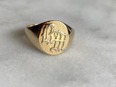 a gold signet ring with an elephant on it