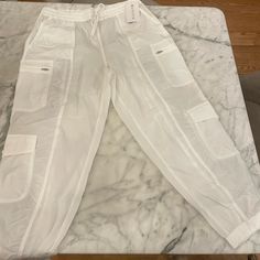 Brand New With Tags Athleta White Cargo Parachute Oants. Size 16. White Casual Joggers With Side Pockets, White Casual Cargo Pants For Loungewear, Casual White Cargo Pants For Loungewear, White Sporty Parachute Pants For Loungewear, Sporty White Parachute Pants For Loungewear, Casual White Parachute Pants With Elastic Waistband, White Activewear With Side Pockets For Workout, White Relaxed Fit Activewear With Side Pockets, White Stretch Parachute Pants