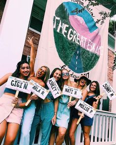 a group of women holding signs in front of a building