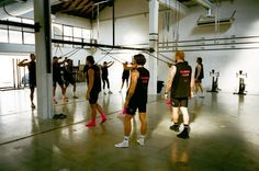 a group of people in a gym doing exercises