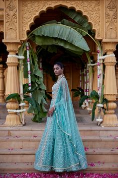 Green dupion silk geometric embroidered lehenga with mirror, Zari and gota detailing paired with halter neck Blouse and tulle scallop edged dupatta.From Chamee and Palak's The Romantics collection.DELIVERY TIMEPlease allow 8-12 weeks for your outfit to arrive.FABRIC DETAILSDupion Silk, NetProfessional cleaning only. Chanderi Sets With Sheer Dupatta For Reception, Raw Silk Dress With Sheer Dupatta For Reception, Gota Work Dress For Reception And Navratri, Wedding Palazzo Set In Tissue Silk With Mirror Work, Reception Palazzo Set With Sheer Dupatta, Bollywood Style Chanderi Gown For Reception, Designer Gown With Dori Work For Diwali, Reception Palazzo Set With Sheer Dupatta In Dola Silk, Designer Dori Work Gown For Diwali