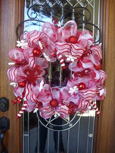 a red and white wreath with candy canes on it