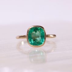 2.38ct Colombian emerald set in solid 14k recycled gold. Antique inspired designs with a brushed finish and minimal milgrain detail around the bezel. This ring would be stunning as an engagement ring or worn as an everyday right hand ring. This ring is currently a size 6 and eligible for a complimentary resize. Once resized, this ring is non-refundable and not eligible for return. If you would like to resize this ring from a size 6, please select your ring size in the drop down menu. Allow 2-3 weeks for processing. Timeless Bezel-set Emerald Ring For May Birthstone, Timeless Bezel Set Emerald Ring For May Birthstone, Timeless Emerald Ring With Bezel Setting For May Birthstone, Timeless May Birthstone Emerald Ring With Bezel Setting, Timeless Emerald Rings With Bezel Setting, Timeless Green Emerald Ring With Bezel Setting, Classic Emerald Ring With Smooth Bezel For Anniversary, Classic Everyday Emerald Solitaire Ring, Classic Yellow Gold Emerald Ring With Smooth Bezel