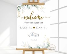 an easel with a welcome sign on it in front of a window that says, welcome to our engagement rachel daniels