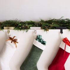 three christmas stockings hanging on the wall