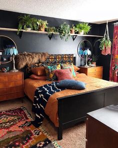 a bed room with a neatly made bed and lots of plants