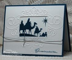 a christmas card with silhouettes of three wise men riding camels and the star of david