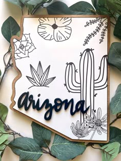 the arizona state is surrounded by green leaves and cactus plants on a white background with black lettering