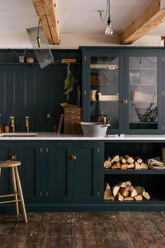 a kitchen with wooden floors and blue cabinets