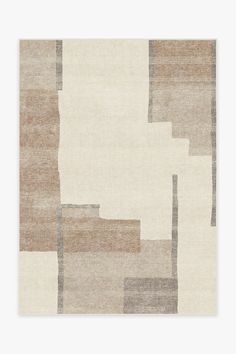 a beige and brown rug with squares on the bottom, in different shades of grey