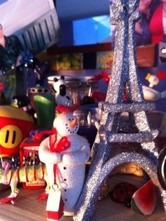 the eiffel tower is surrounded by toys and other things in front of it