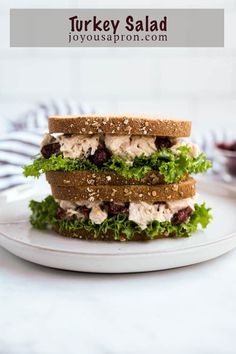 two sandwiches stacked on top of each other with lettuce and chicken in the middle