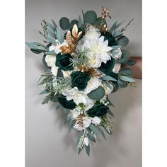 a bridal bouquet with white and green flowers