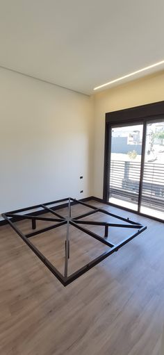 an empty room with wooden floors and sliding glass doors