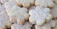 a pile of cookies with powdered sugar on top