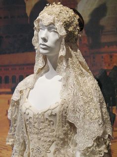 a mannequin wearing a wedding dress and veil