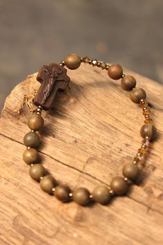 "+.This is a rosary bracelet created of Swarovski crystal beads and 'Lignum Vitae' wood. << wooden crucifix>> +. There is a wood called ''Lignum Vitae\" It has the meaning of 'a tree that heals wounds'. It is a sacred tree also called the tree of life and green heart. +.The tree grows very slowly, making it one of the hardest woods. It is even called 'iron wood'. +. The reason why 'lignum vitae' is called these names is because of the perfume oil (oil with a fragrant smell) contained in it A swe Spiritual Rosary Bracelet With Faceted Beads As Gift, Spiritual Rosary Bracelet With Polished Beads, Adjustable Spiritual Rosary Bracelet With Faceted Beads, Spiritual Rosary Bracelet With Round Beads As Gift, Gift Rosary Bracelet With 8mm Beads And Crucifix, Spiritual Rosary Bracelet With Faceted Round Beads, Spiritual Rosary Bracelet With Round Beads For Jewelry Making, Spiritual Rosary Bracelet For Jewelry Making, Adjustable Spiritual Rosary Bracelet With Spacer Beads