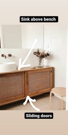 an image of a bathroom with sink above bench and sliding doors