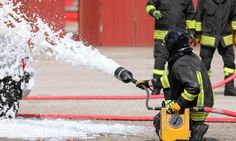 a firefighter is using a hose to extinguish water