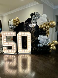 a 50th birthday party with balloons and lights