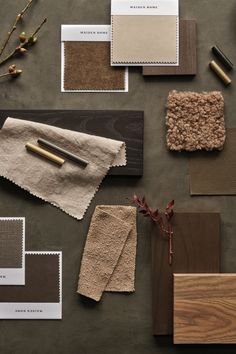 various shades of brown and white are arranged on a table with wood, paper, and paint samples