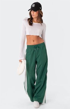 These track pants offer both style and comfort, making them perfect for a sporty yet fashionable look. They're ideal for any activity, ensuring you feel comfortable and confident throughout your entire day.Track pantsSide stripe detailDrawstring waistbandNylon fabricPolyesterModel wears size SModel height is 5'6Item care: Wash with similar color Edikted Womens Fauna Track Pants - Green size Small Nylon Track Pants, Track Pants Outfit, Track Pants Women, Side Stripe, Sport Pants, Pants Outfit, S Models, Fashion Pants, Track Pants