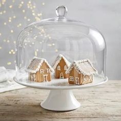 two gingerbread houses under a glass dome