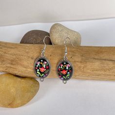 These dark floral drop earrings are colorful and fun. Dark floral vibes with silver accents. Black Dangle Flower Earrings With Ear Wire, Bohemian Black Flower Earrings For Gift, Bohemian Drop Earrings With Floral Print, Floral Print Drop Earrings As Gift, Bohemian Floral Print Drop Earrings, Bohemian Black Dangle Flower Earrings, Black Bohemian Dangle Flower Earrings, Black Flower Drop Earrings For Gift, Multicolor Floral Print Earrings For Gift