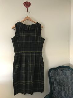 This plaid R&K dress is a dream. The colors are perfection with a blend of gray, blue and pistachio green. She even has pockets and who doesn't love dress pockets. This 1980's dress is in excellent condition. Body is poly and rayon blend and the bodice is lined, skirt is not.  Size is 12, but please check measurements below as vintage runs small.  Approximate measurements in inches, laid flat: shoulder to shoulder 14" across underarm to underarm 18" across waist 16" across  sleeve length from shoulder 24" length, shoulder to hem 21" Vintage clothing cannot be returned, so please check all information about the condition and size before purchase. I would be happy to answer any questions about the piece. Vintage Green Dress With Pockets, Sleeveless Plaid Dress With Pockets, Vintage Plaid Workwear Dress, Vintage Sleeveless Spring Plaid Dress, Fitted Sleeveless Vintage Plaid Dress, Plaid Cotton Vintage Dress, Vintage Plaid Sleeveless Dress, Vintage Plaid A-line Dress, Plaid Dress Vintage