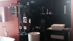 a bathroom with red walls and black cabinets